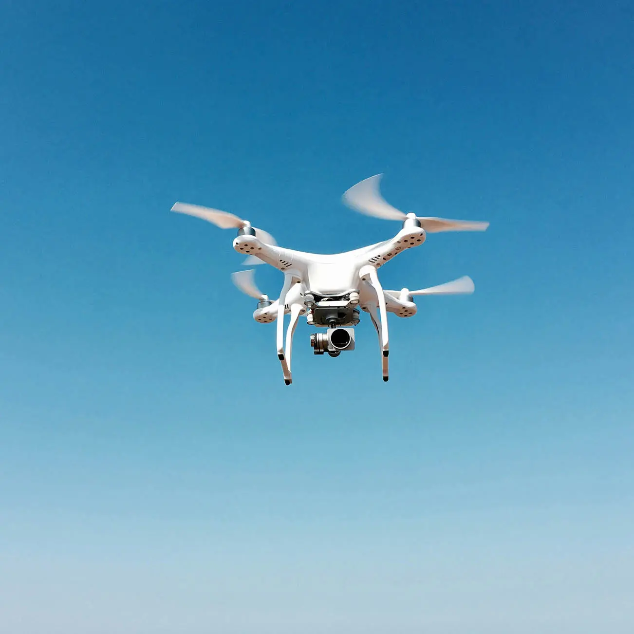 drone flying against blue sky