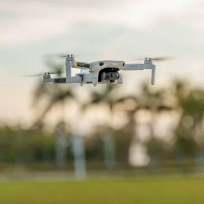 drone flying with palm trees in the background