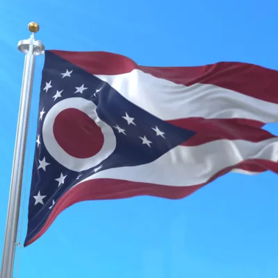 State of Ohio flag flying in the sky representing its leadership in advanced air mobility (AAM)