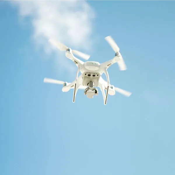 0506-drone drone flying overhead in the blue sky