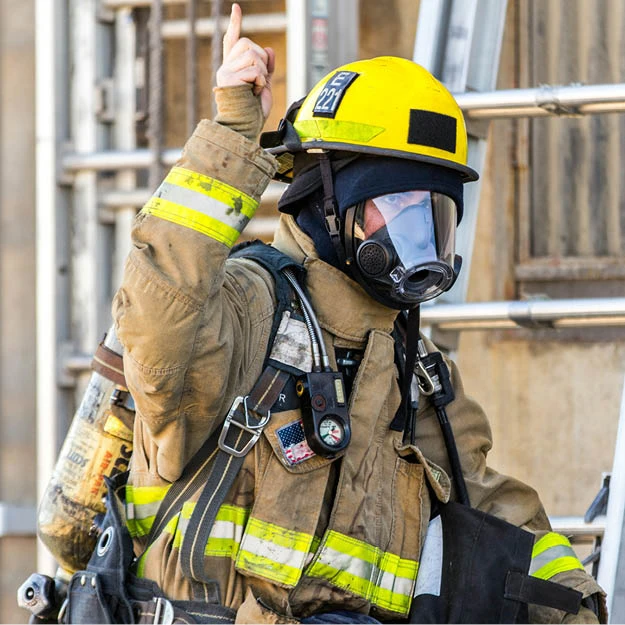 First responder pointing upward toward drone